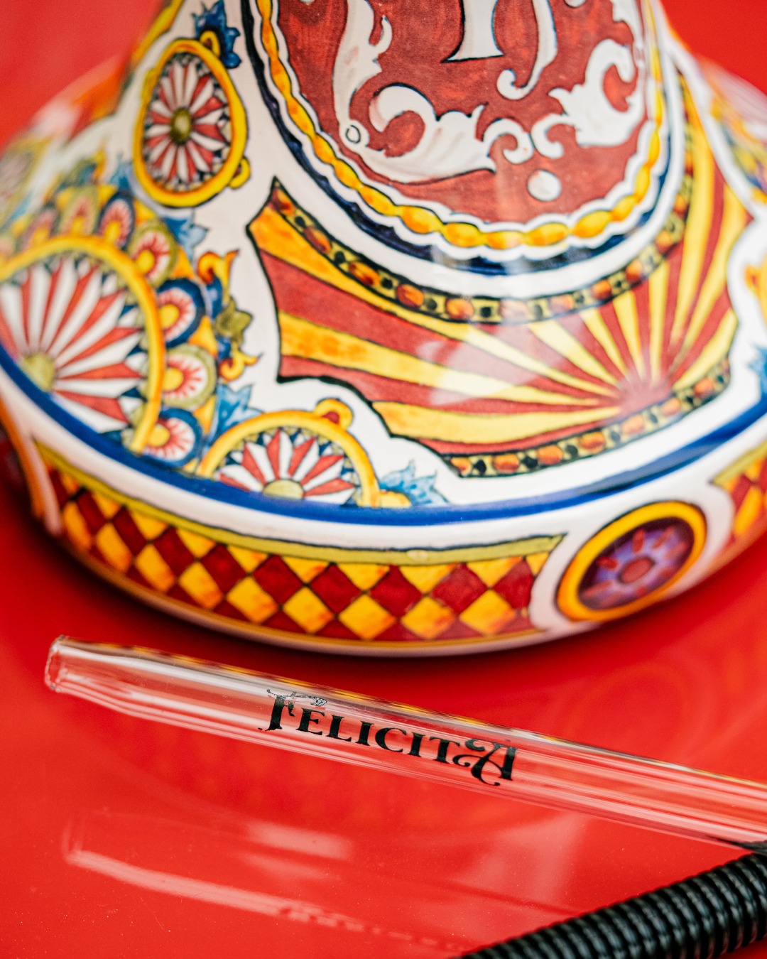 Olla Felicita hookah base detail and glass mouthpiece on red